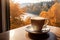 a hot mug of coffee overlooking the autumn landscape outside the window. ai generative