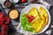 Hot omelet on a white plate, flatlay