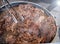 Hot pan with veal shank and steam. Cooking Beef veal shank, close up photo