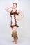 Hot plus size woman in fur carnival costume of primitive man on white background in Studio. a beautiful savage girl in a brown dre