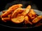 Hot potato wedges on black plate