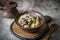 Hot potatoes with meat in a beautiful clay plate. Hot soup in bowl on vintage grey background