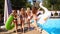 Hot pretty girls in bikini walking together with inflatable swan and swim ring by pool. Attractive fitted women in