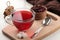 Hot red karkade tea in glass cups with dry tea on a white wooden table