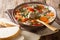 Hot rich Italian soup with orzo pasta, chicken meatballs and vegetables close-up in a bowl. horizontal