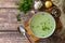 Hot rich meat broth with herbs on a rustic table. Top view flat lay background. Copy space