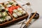 Hot rolls with eel, Japanese omelette, cream cheese, fried onions and unagi sauce, decorated with fresh herbs. Japanese food on a