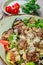 Hot salad with veal, mushrooms, salad leaves, eggplant, zucchini, tomatoes,