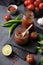 Hot sauce adjika. Homemade appetizer with peppers and tomatoes in a jar on a dark background with vegetables and herbs. Rustic