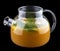 Hot sea buckthorn tea with mint in a glass teapot. On dark background