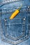 Hot sensations concept. Pepper in back pocket of blue jeans. Pocket of jeans staffed with yellow chilly pepper, denim