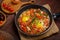 hot shakshuka in a frying pan sprinkled with green onions on the Shabbat table.