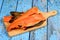 Hot smoked salmon bones on wooden kitchen board. Blue wooden board background.