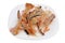 Hot smoked   salmon waste  trims  -  bones and fins  as low cost delicacy on plate isolated macro