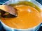 Hot smooth cooked salty caramel sauce in steel pan