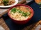 hot and sour noodles with green onion served in a bowl isolated on table top view of taiwanese food