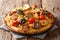 Hot spicy penne pasta with fried chicken, wild mushrooms, smoked sausage, tomatoes and creamy cheese sauce close-up on a plate on