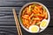 Hot and spicy rice cake Tteokbokki recipe close-up in a bowl. horizontal top view