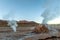 Hot spring at El Tatio Geysers with steaming geysers, hot springs, boiling water all around at sunrise, Chile, South America