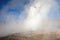 Hot spring at El Tatio Geysers with steaming geysers, hot springs, boiling water all around at sunrise, Chile, South America