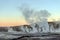 Hot spring at El Tatio Geysers with steaming geysers, hot springs, boiling water all around at sunrise, Chile, South America