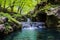 a hot spring flowing down as a small waterfall