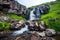 a hot spring waterfall cascading down a mountain