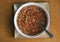 Hot, steaming bowl of beef barley soup on table