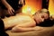 Hot stone massage at spa salon in luxury resort with warm candle light.Quiescent