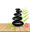 Hot stone massage on wooden table