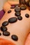 Hot stones lined on young woman\'s back for massage