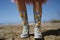 Hot Summer beach with legs and cute colorful girly flower printed motif plastic boots - generative AI