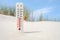 Hot summer day. Celsius and fahrenheit scale thermometer in the sand. Ambient temperature plus 12