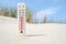 Hot summer day. Celsius and fahrenheit scale thermometer in the sand. Ambient temperature plus 24