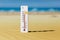 Hot summer day. Thermometer in the sand shows plus 40 degrees celsius