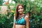 Hot summer. Portrait of a beautiful tanned, slender woman in a swimsuit poses in the refreshing tropical rain. Summer vacation and