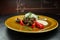 Hot tasty pork cutlet with vegetables and sour cream spicy sauce on a wooden table in a restaurant. Great breakfast for gourmet.