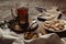 Hot tea in antique cup holder with sugar cookies on old brown wooden background.