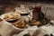 Hot tea in antique cup holder with sugar cookies on old brown wooden background.