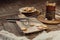 Hot tea in antique cup holder with sugar cookies on old brown wooden background. Rustic style.