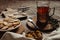 Hot tea in antique cup holder with sugar cookies on old brown wooden background. Rustic style.