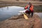 hot tea break - senior male paddler with a decked expedition canoe with a wooden paddle on a shore of Horsetooth Reservoir