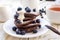 Hot tea and buckwheat chocolate pancakes with blueberries