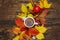 Hot tea with colorful autumn leaves, acorns, cinnamon and rosehip berries