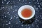 Hot tea cup frozen lake background