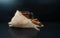 Hot tea cup glass on a autumn/winter day with cinnamon and burlap/hessian at a black background