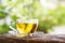 Hot tea cup on wooden table with background of nature sunlight