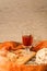 Hot Tea in glass cup with cinnamon sticks tea leaves and cookies on wooden table and knitted scarf around