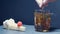 Hot tea is poured into a glass. Transparent glass teapot and teacup. Slow motion