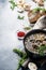 Hot thick mushroom soup with beef, spices and wholegrain barley, meat broth. With black bread, in metal pan, top view, flat lay,